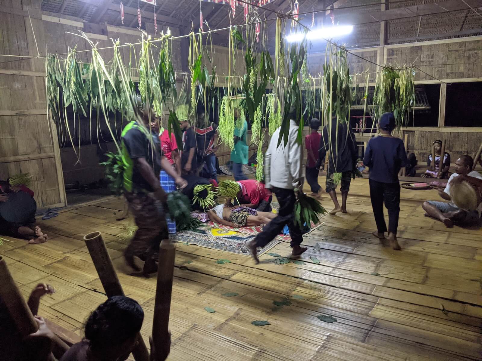 Villagers chanted spells and danced to the beats of drums and bamboo sticks as they pray for the health of Muna Angah (middle). (YH Law)