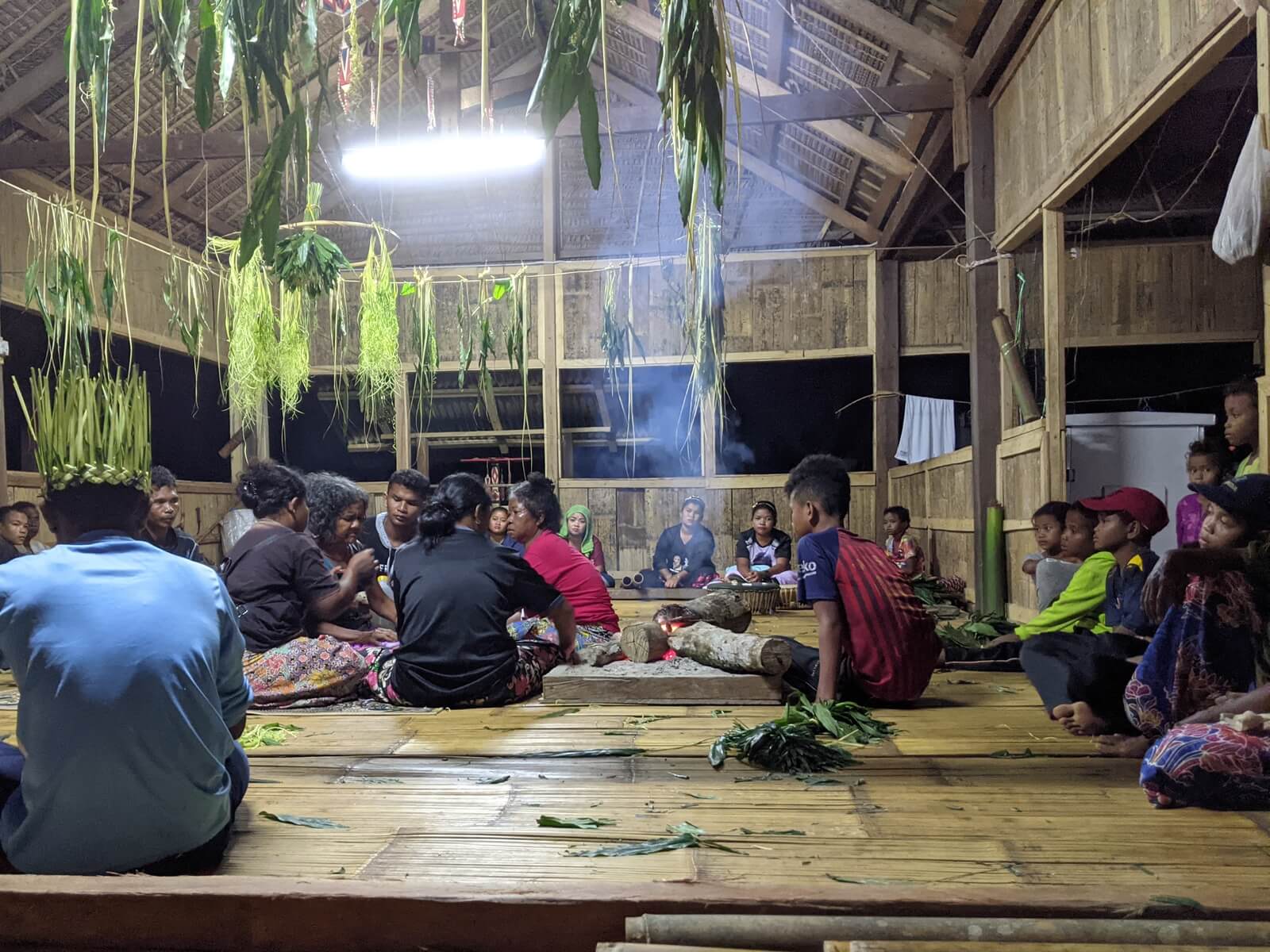 Villagers feed and comfort the ailing Muna Angah after the sewang. (YH Law)